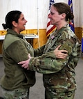 Jennifer Hillyer is embraced by her friend, Sgt. 1st Class Misty Mesecher, following her retirement ceremony on January 9.