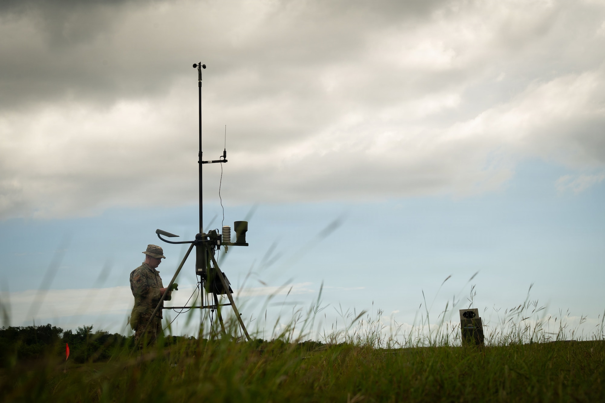 An Airman assembles weather measuring equipment.