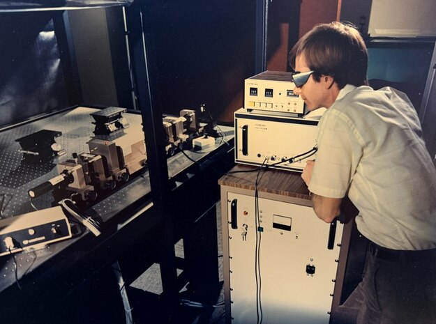Dr. Kerry Commander, then NSWC PCD physicist, conducts optoacoustic transduction testing at the command’s Laser Lab in the late 1980s. This test was to allow the fleet to communicate across the air-water interface by converting laser energy into acoustic pulses. (courtesy photo)