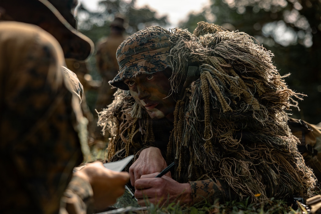 U.S. Marine Corps Lance Cpl. Jeffrey Hollabaugh, a rifleman with 4th Light Armored Reconnaissance, forward deployed with 4th Marine Regiment, 3rd Marine Division as part of the Unit Deployment Program, conducts a land navigation class before their patrol exercise on Camp Schwab, Okinawa, Japan, Jan. 6, 2026. The patrolling exercise was conducted to sustain and improve Marines’ operating skills in disaggregated and contested environments. Hollabaugh is a native of Virginia. (U.S. Marine Corps photo by Cpl. Joaquin Dela Torre)