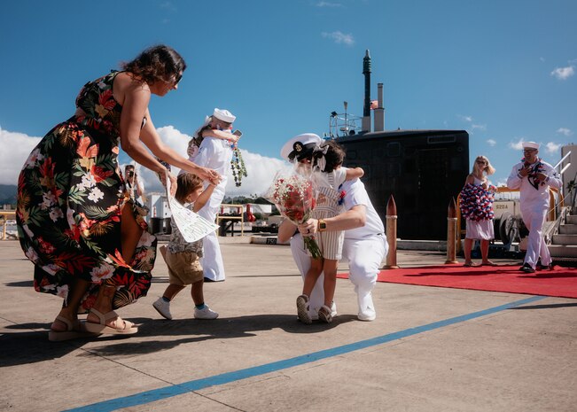 JOINT BASE PEARL HARBOR-HICKAM, Hawaii (Dec 8, 2025) - Senior Chief Culinary Specialist Vince Morales, assigned to Virginia-class fast-attack submarine USS Hawaii (SSN 776), meets his family pierside as Hawaii returns to its homeport at Joint Base Pearl Harbor-Hickam following a scheduled deployment, Dec. 8, 2025. Hawaii is assigned to Submarine Squadron 1 and is capable of supporting various missions, including anti-submarine warfare, anti-surface ship warfare, strike warfare, special operations forces support, and intelligence, surveillance, and reconnaissance. (U.S. Navy photo by Mass Communication Specialist 2nd Class Nicholas Russell)