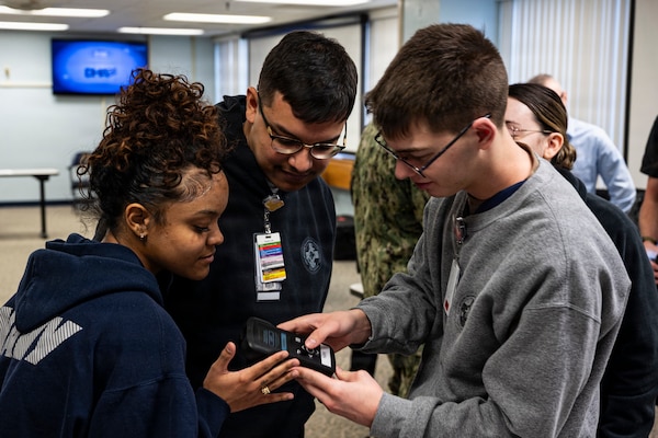 Hospital Corpsmen assigned to Naval Medical Center Camp Lejeune read results on a Traumatic Brain Injury assessment device during an end-user touchpoint hosted by the Operational Medical Systems Program Management Office, Camp Lejeune, North Carolina, Jan. 14, 2026. The touchpoint at NMCCL is one in a series of planned engagements with prospective end users to help the OPMED Warfighter Readiness, Performance and Brain Health project management office refine the development of field-portable TBI detection devices designed for use in austere, remote locations across the globe. OPMED, part of the Defense Health Agency, partners with stakeholders across the Joint Force to develop, acquire, and field medical devices, treatments, and frontline care solutions for military medical providers to fill capability gaps with the speed of relevance. (Defense Health Agency photo by T. T. Parish/Released)