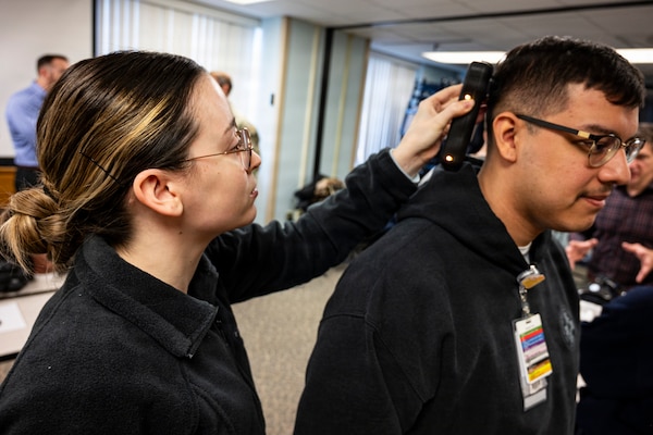 Hospital Corpsman 3rd Class Mikayla Bobbing operates a near infrared Traumatic Brain Injury assessment device during an end-user touchpoint hosted by the Operational Medical Systems Program Management Office, Camp Lejeune, North Carolina, Jan. 14, 2026. Bobbing, originally from the Philadelphia area, is assigned to the Naval Medical Center Camp Lejeune. The touchpoint at NMCCL is one in a series of planned engagements with prospective end users to help the OPMED Warfighter Readiness, Performance and Brain Health project management office refine the development of field-portable TBI detection devices designed for use in austere, remote locations across the globe. OPMED, part of the Defense Health Agency, partners with stakeholders across the Joint Force to develop, acquire, and field medical devices, treatments, and frontline care solutions for military medical providers to fill capability gaps with the speed of relevance. (Defense Health Agency photo by T. T. Parish/Released)