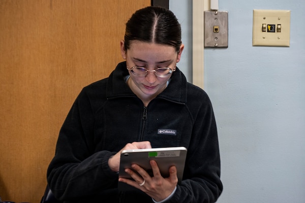 Hospital Corpsman 3rd Class Mikayla Bobbing provides feedback after participating in an end-user touchpoint hosted by the Operational Medical Systems Program Management Office, Camp Lejeune, North Carolina, Jan. 14, 2026. Bobbing, originally from the Philadelphia area, is assigned to the Naval Medical Center Camp Lejeune. The touchpoint at NMCCL is one in a series of planned engagements with prospective end users to help the OPMED Warfighter Readiness, Performance and Brain Health project management office refine the development of field-portable TBI detection devices designed for use in austere, remote locations across the globe. OPMED, part of the Defense Health Agency, partners with stakeholders across the Joint Force to develop, acquire, and field medical devices, treatments, and frontline care solutions for military medical providers to fill capability gaps with the speed of relevance. (Defense Health Agency photo by T. T. Parish/Released)