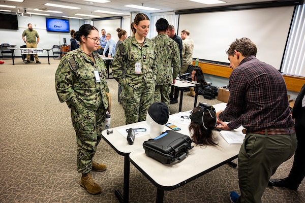 Hospital Corpsmen assigned to Naval Medical Center Camp Lejeune learn about the Traumatic Brain Injury Field Assessment Program during an end-user touchpoint hosted by the Operational Medical Systems Program Management Office, Camp Lejeune, North Carolina, Jan. 14, 2026. The touchpoint at NMCCL is one in a series of planned engagements with prospective end users to help the OPMED Warfighter Readiness, Performance and Brain Health project management office refine the development of field-portable TBI detection devices designed for use in austere, remote locations across the globe. OPMED, part of the Defense Health Agency, partners with stakeholders across the Joint Force to develop, acquire, and field medical devices, treatments, and frontline care solutions for military medical providers to fill capability gaps with the speed of relevance. (Defense Health Agency photo by T. T. Parish/Released)