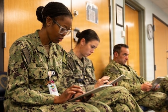 U.S. Navy medical officers provide feedback after participating in an end-user touchpoint hosted by the Operational Medical Systems Program Management Office, Camp Lejeune, North Carolina, Jan. 14, 2026. The touchpoint at NMCCL is one in a series of planned engagements with prospective end users to help the OPMED Warfighter Readiness, Performance and Brain Health project management office refine the development of field-portable TBI detection devices designed for use in austere, remote locations across the globe. OPMED, part of the Defense Health Agency, partners with stakeholders across the Joint Force to develop, acquire, and field medical devices, treatments, and frontline care solutions for military medical providers to fill capability gaps with the speed of relevance. (Defense Health Agency photo by T. T. Parish/Released)