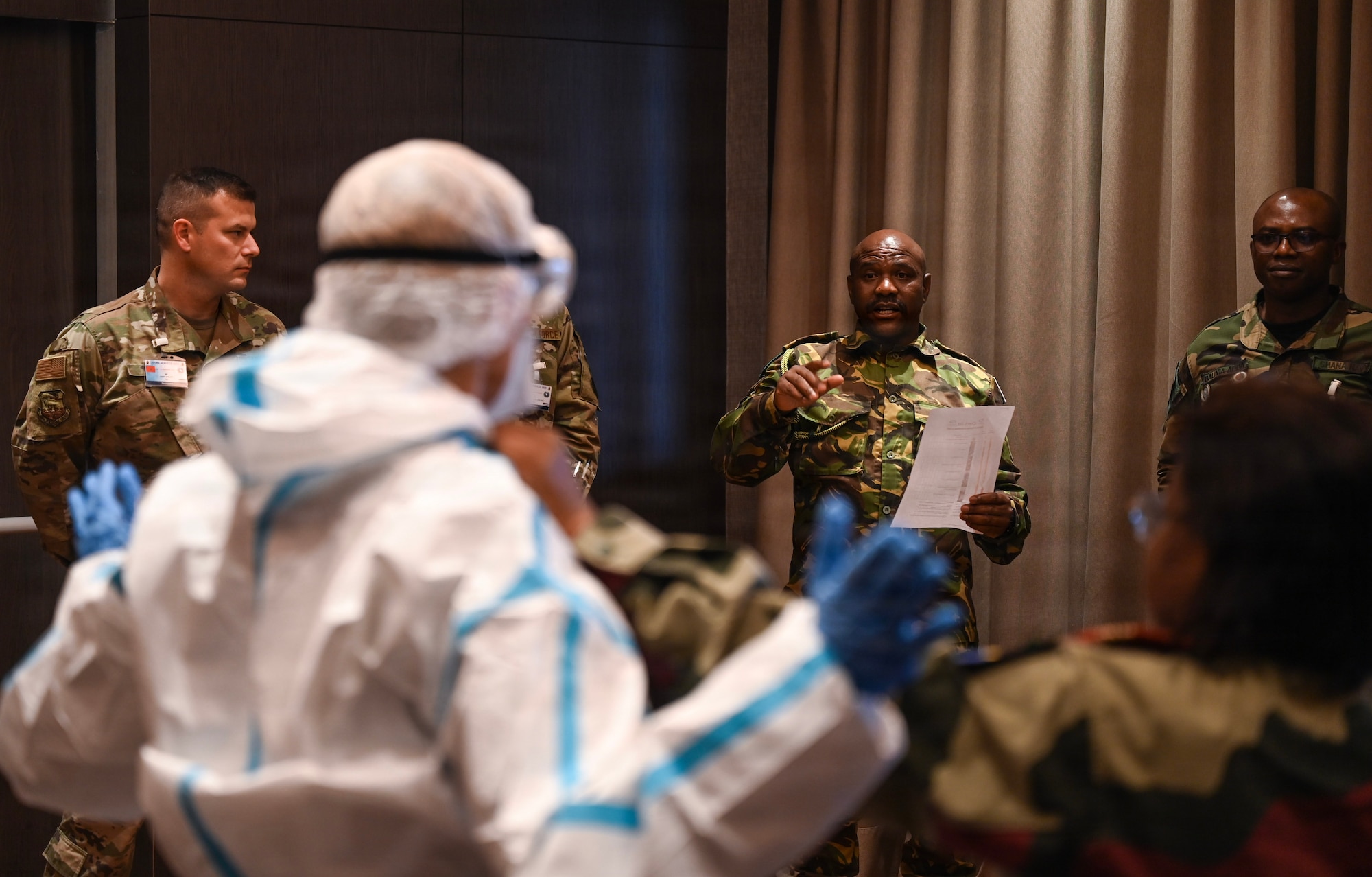 Lesotho Defence Force Lt. Nkoe Leruo, Lesotho Defence Force lab tech, provides input during a demonstration of donning and doffing personal protective equipment during the African Partner Outbreak Response Alliance 2025 Workshop in Rabat, Morocco, Dec. 9, 2025. APORA 2025 brought together delegates from 30 African countries to come together and share lessons learned, techniques, tactics and procedures and discuss how to strengthen infectious disease outbreak response interoperability between military and civil organizations, countries and regional partners. (U.S. Air Force photo by Capt. Benjamin Aronson)