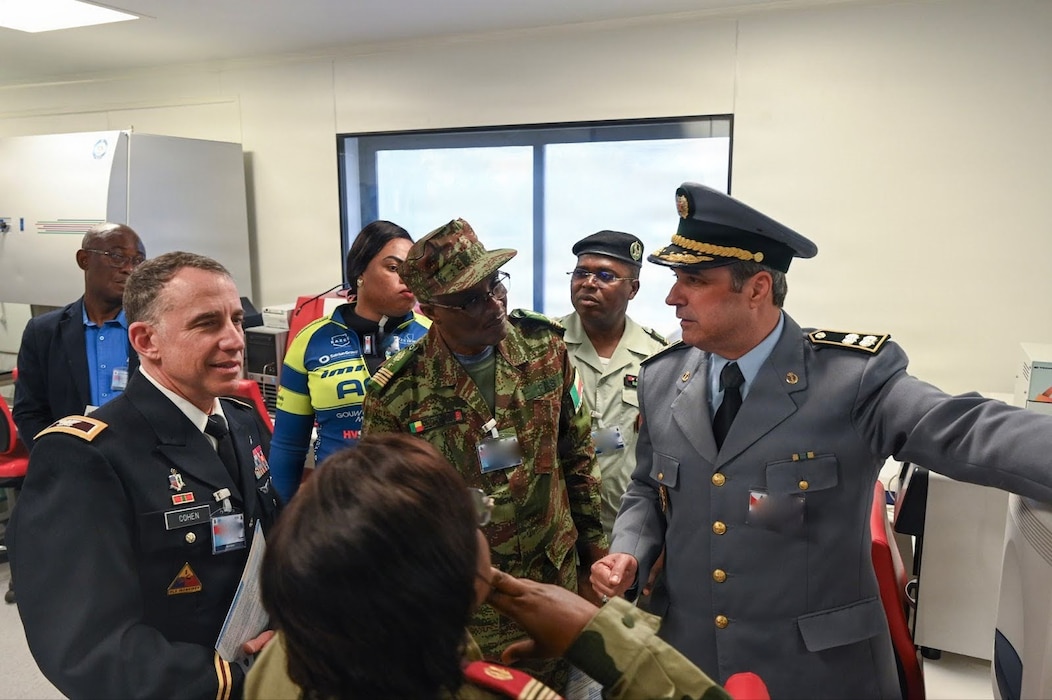 U.S. Army Col. Michael Cohen, U.S. Africa Command command surgeon, far left, receives a briefing along with other the African Partner Outbreak Response Alliance 2025 Workshop attendees from Moroccan Armed Forces Col. Idriss Lahlou Amine, Mohammed V Military Training Hospital virology laboratory chief, far right, during a hospital tour in Rabat, Morocco, Dec. 10, 2025. Members attending the APORA 2025 Workshop received a tour of the hospital to see first-hand how the Moroccan Armed Forces respond and treat infectious diseases. (U.S. Air Force photo by Capt. Benjamin Aronson) (This photo was altered for security purposes by blurring security badges.)