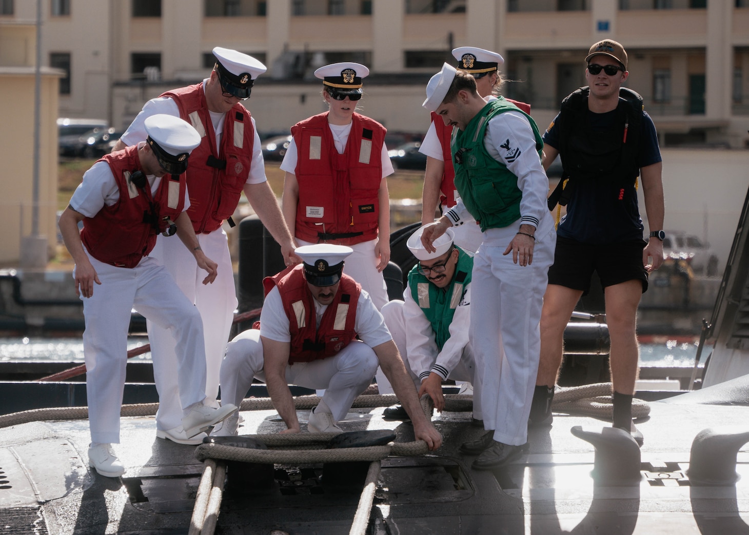 JOINT BASE PEARL HARBOR-HICKAM, Hawaii (Dec 8, 2025) - Sailors assigned to Virginia-class fast-attack submarine USS Hawaii (SSN 776) adjust mooring lines as Hawaii returns to its homeport at Joint Base Pearl Harbor-Hickam following a scheduled deployment, Dec. 8, 2025. Hawaii is assigned to Submarine Squadron 1 and is capable of supporting various missions, including anti-submarine warfare, anti-surface ship warfare, strike warfare, special operations forces support, and intelligence, surveillance, and reconnaissance. (U.S. Navy photo by Mass Communication Specialist 2nd Class Nicholas Russell)