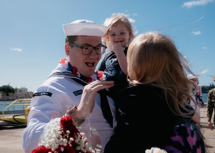 JOINT BASE PEARL HARBOR-HICKAM, Hawaii (Dec 8, 2025) - Machinist’s Mate (Nuclear) 2nd Class Robert Turner, assigned to Virginia-class fast-attack submarine USS Hawaii (SSN 776), meets his family pierside as Hawaii returns to its homeport at Joint Base Pearl Harbor-Hickam following a scheduled deployment, Dec. 8, 2025. Hawaii is assigned to Submarine Squadron 1 and is capable of supporting various missions, including anti-submarine warfare, anti-surface ship warfare, strike warfare, special operations forces support, and intelligence, surveillance, and reconnaissance.  (U.S. Navy photo by Mass Communication Specialist 2nd Class Nicholas Russell)
