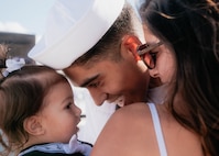 JOINT BASE PEARL HARBOR-HICKAM, Hawaii (Dec 8, 2025) - Electronics Technician (Nuclear) 2nd Class Xavier Nuñez, assigned to Virginia-class fast-attack submarine USS Hawaii (SSN 776), meets his wife and daughter pierside as Hawaii returns to its homeport at Joint Base Pearl Harbor-Hickam following a scheduled deployment, Dec. 8, 2025. Hawaii is assigned to Submarine Squadron 1 and is capable of supporting various missions, including anti-submarine warfare, anti-surface ship warfare, strike warfare, special operations forces support, and intelligence, surveillance, and reconnaissance. (U.S. Navy photo by Mass Communication Specialist 2nd Class Nicholas Russell)