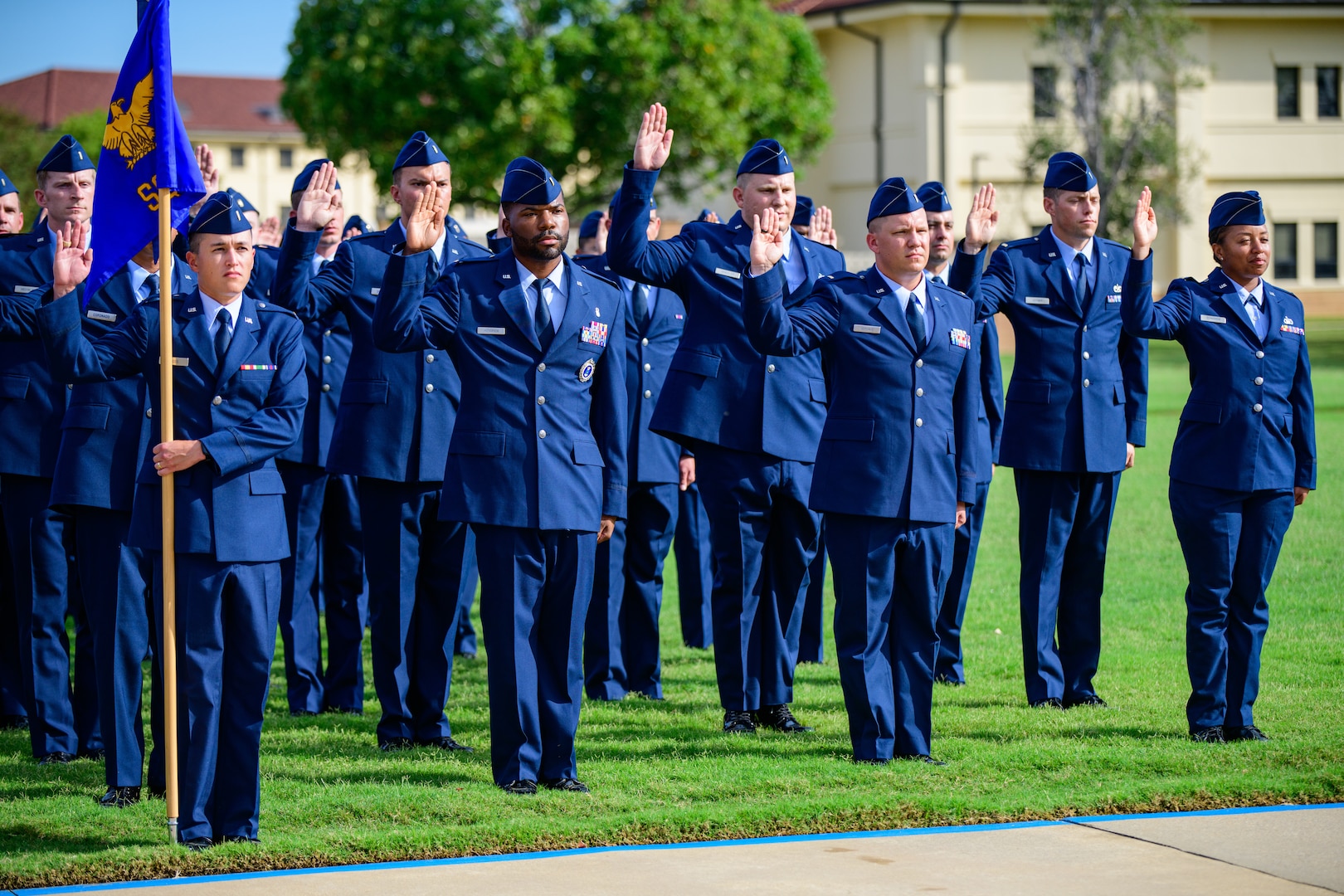 2nd Lt. Chavis Kendrick raises his right hand and takes the oath of office during his commissioning ceremony at Officer Training School.