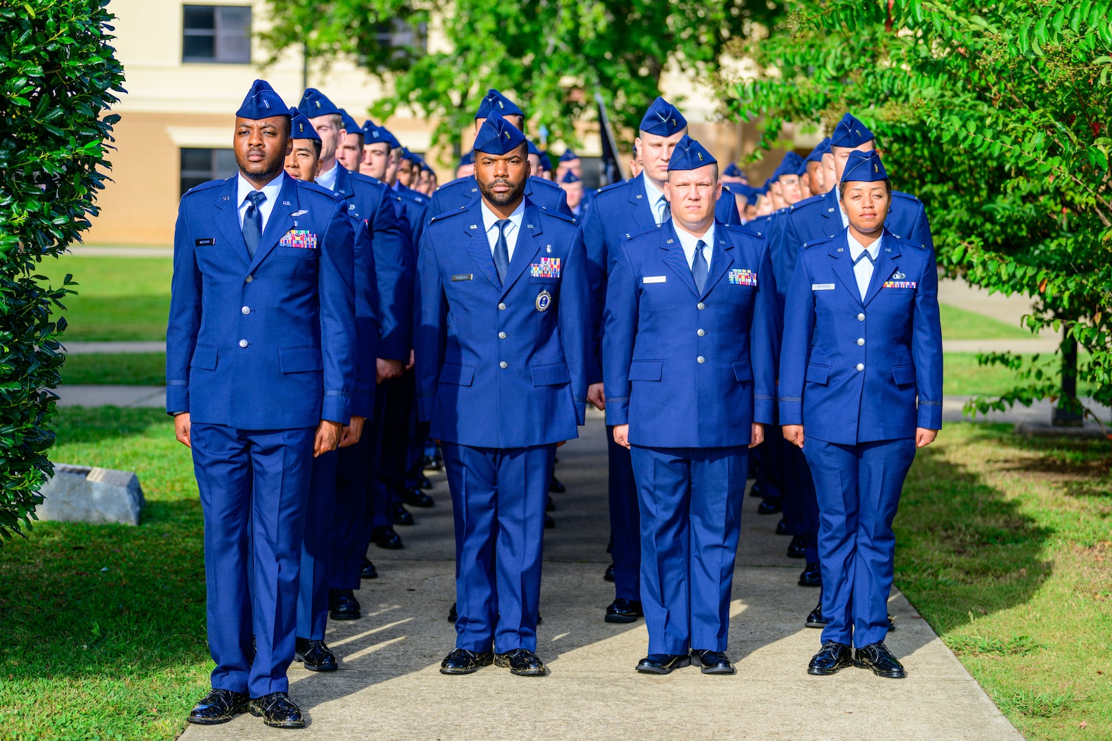 U.S. Air Force officer candidates march in formation during an Officer Training School commissioning ceremony. Among the candidates is 2nd Lt. Chavis Kendrick, a former enlisted Airman assigned to the 60th Medical Group.