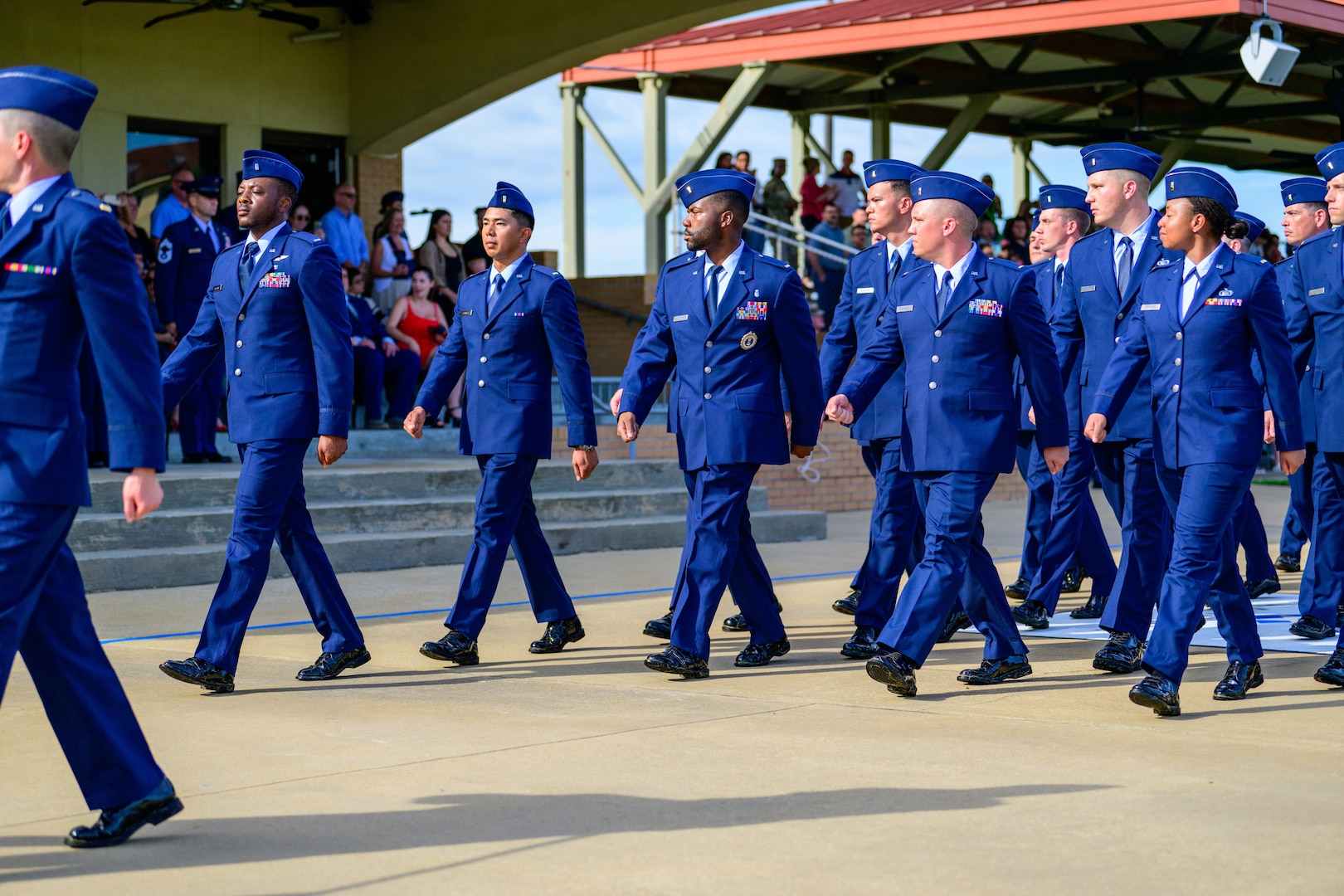 Officer candidates march during an Officer Training School commissioning ceremony, marking their transition from enlisted service to commissioned officers. Kendrick earned his commission after multiple application attempts.