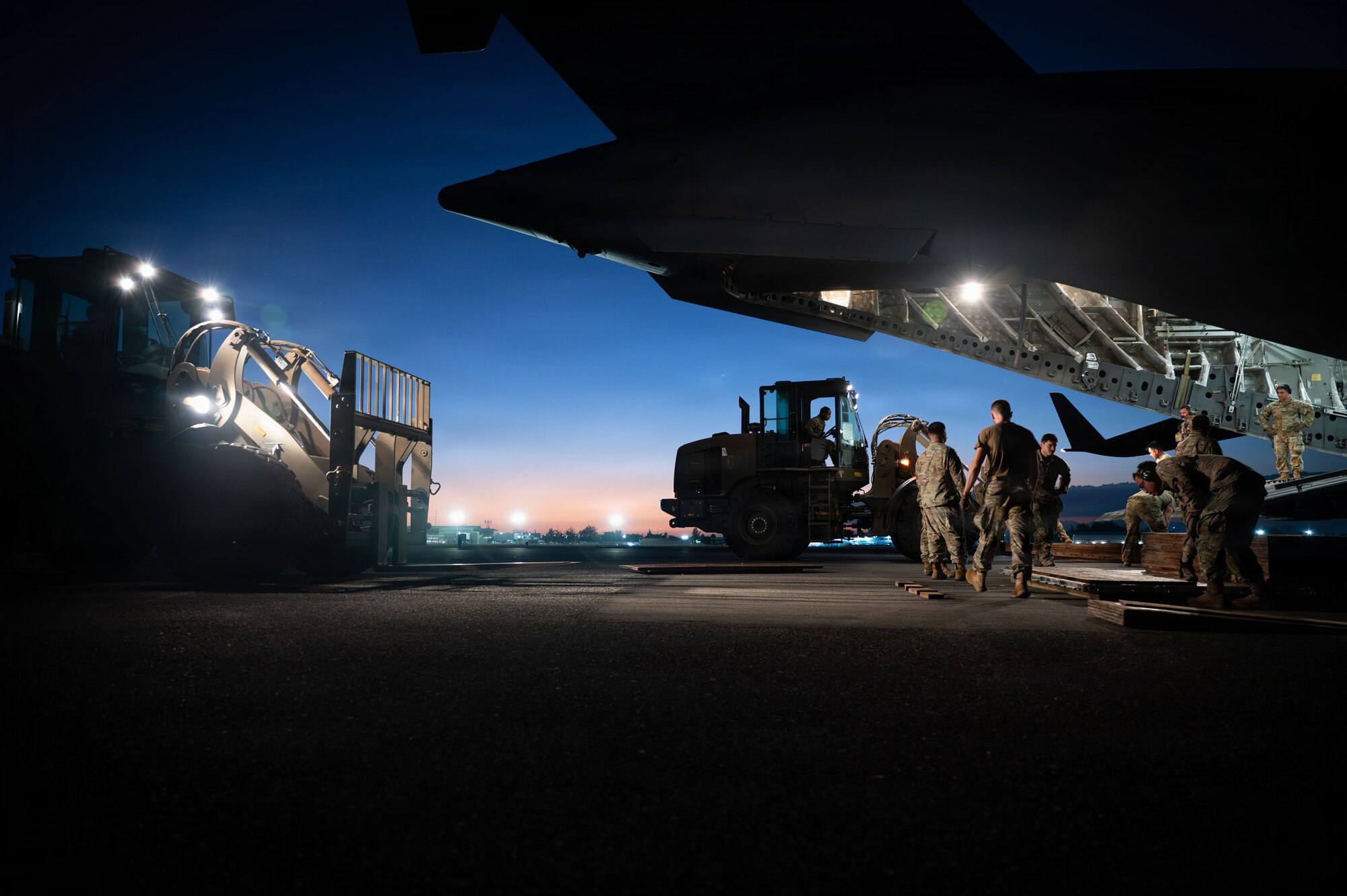 Airmen remove cargo from a C-17 cargo plane.