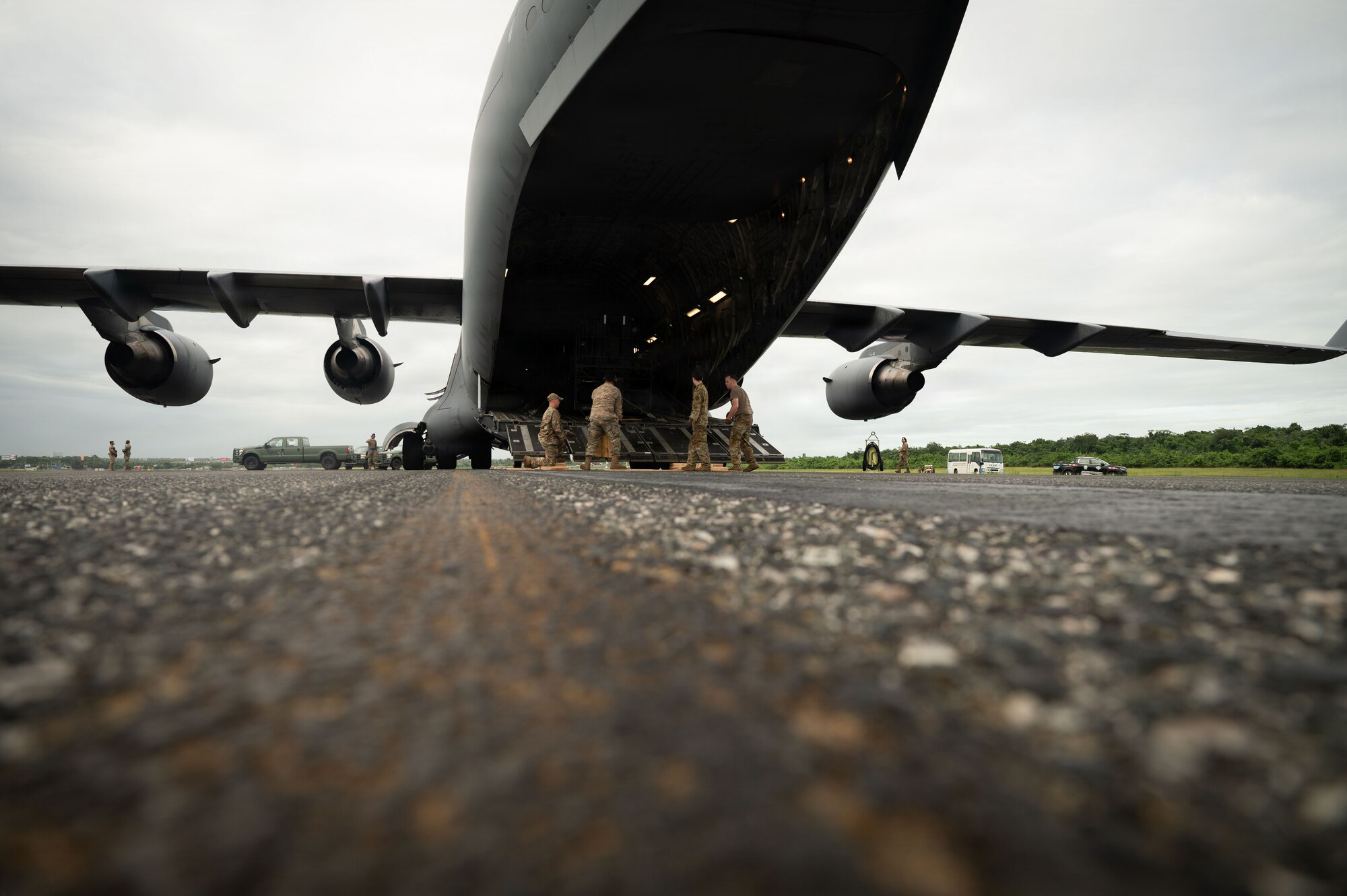 Airmen remove cargo from a C-17 cargo plane.