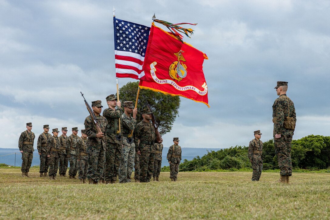 U.S. Marines with III Marine Expeditionary Force present the colors during an activation ceremony for 3rd Marine Expeditionary Brigade at Camp Courtney, Okinawa, Japan, Jan. 13, 2026. The 3rd MEB established a new headquarters company to enhance their lethality by centralizing command and synchronizing readiness efforts across warfighting functions. (U.S. Marine Corps photo by Lance Cpl. Justin Cledera)