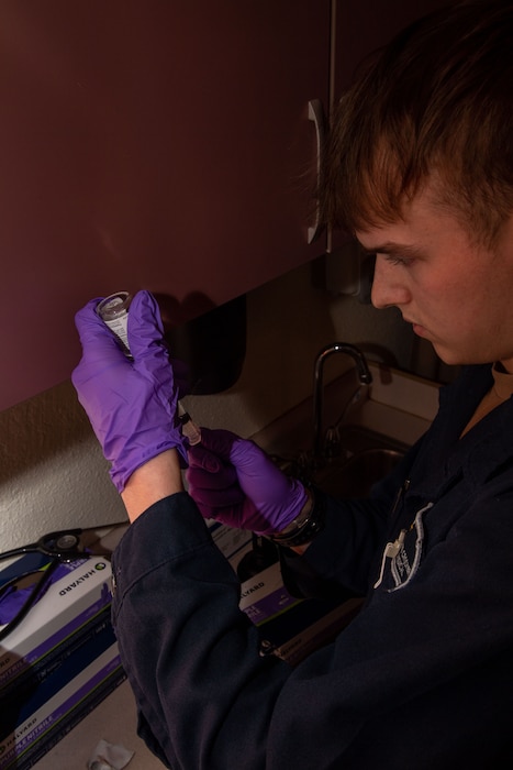 Hospital Corpsman Seaman Apprentice Jakeb Crocker prepares a vaccine aboard Nimitz-class aircraft carrier USS Carl Vinson (CVN 70), Dec. 19, 2025. Carl Vinson is undergoing scheduled maintenance in its homeport of San Diego while remaining a combat-ready force dedicated to protecting and defending the United States. (U.S. Navy photo by Mass Communication Specialist Seaman Apprentice Kobe Lucas)