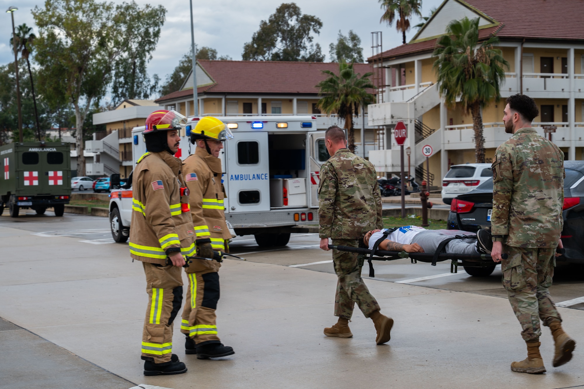 Airmen transport simulated victim to ambulance.