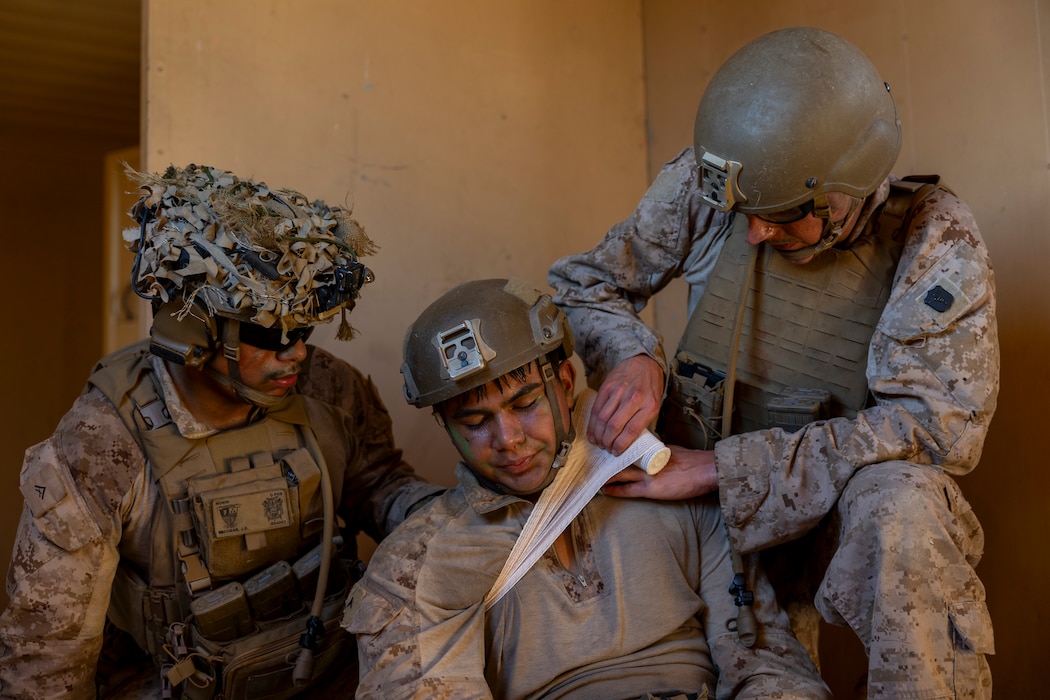 U.S. Navy Hospital Corpsman Samuel Brewer III, right, with India Company, Battalion Landing Team 3/5, 11th Marine Expeditionary Unit, provides aid to a simulated casualty during patrol base operations on Marine Corps Base Camp Pendleton, Dec. 8, 2025. The 11th MEU is currently underway aboard the Boxer Amphibious Ready Group in the U.S. 3rd Fleet area of operations conducting integrated training that enhances lethality and warfighting readiness. (U.S. Marine Corps photo by Cpl. Oliver Nisbet)