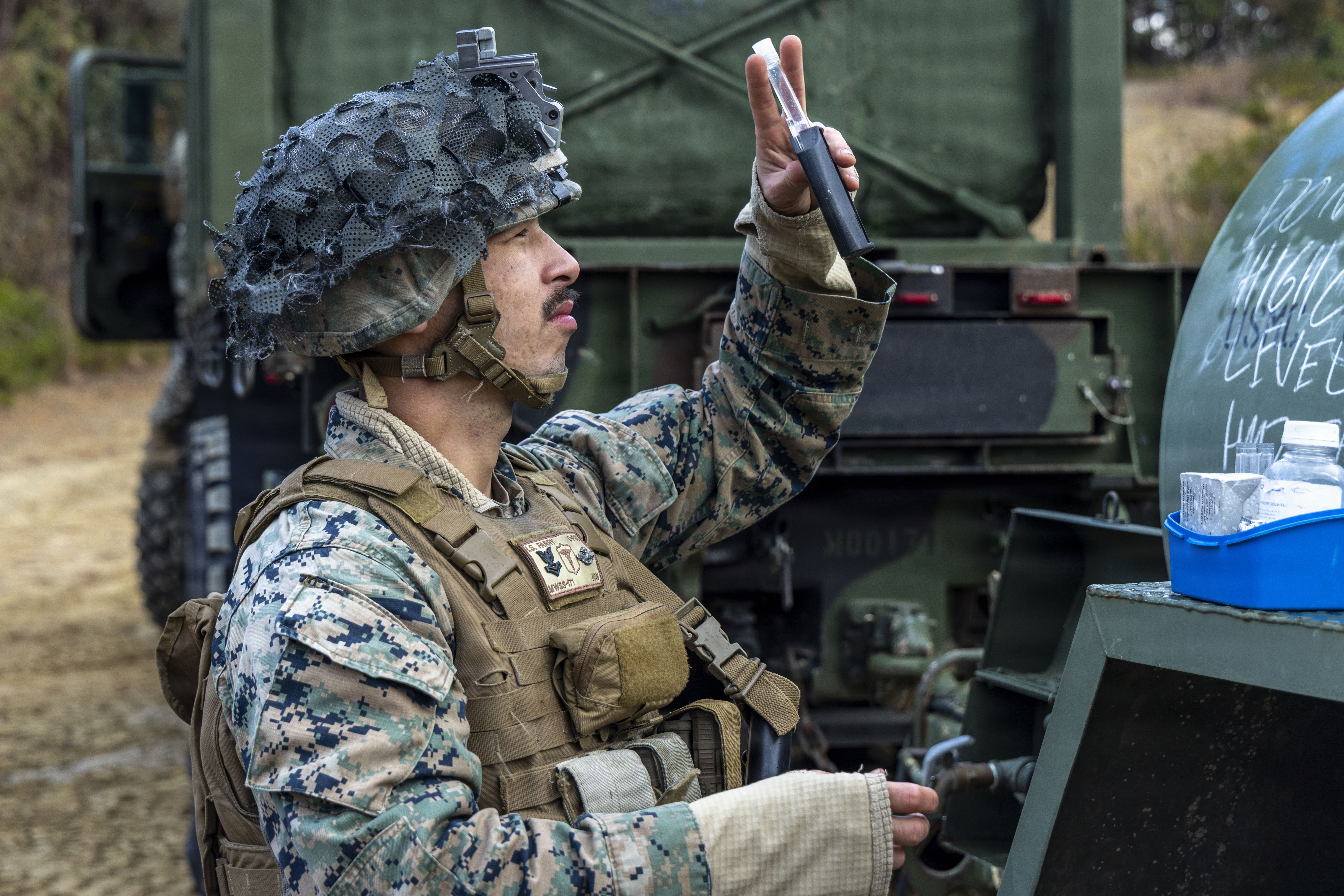 U.S. Navy Hospital Corpsman HM2 Ian Farry with Marine Wing Support Squadron 171, Marine Aircraft Group 12, 1st Marine Aircraft Wing, checks the chlorine level of a water tank at Haramura Training Area, Hiroshima, Japan, Dec. 5, 2025. MWSS-171 traveled to Hiroshima to conduct field training and complete the beautification of the training area for the Japanese Self-Defense Force. Farry is a native of California. (U.S. Marine Corps Photo by Cpl. Chloe Johnson)