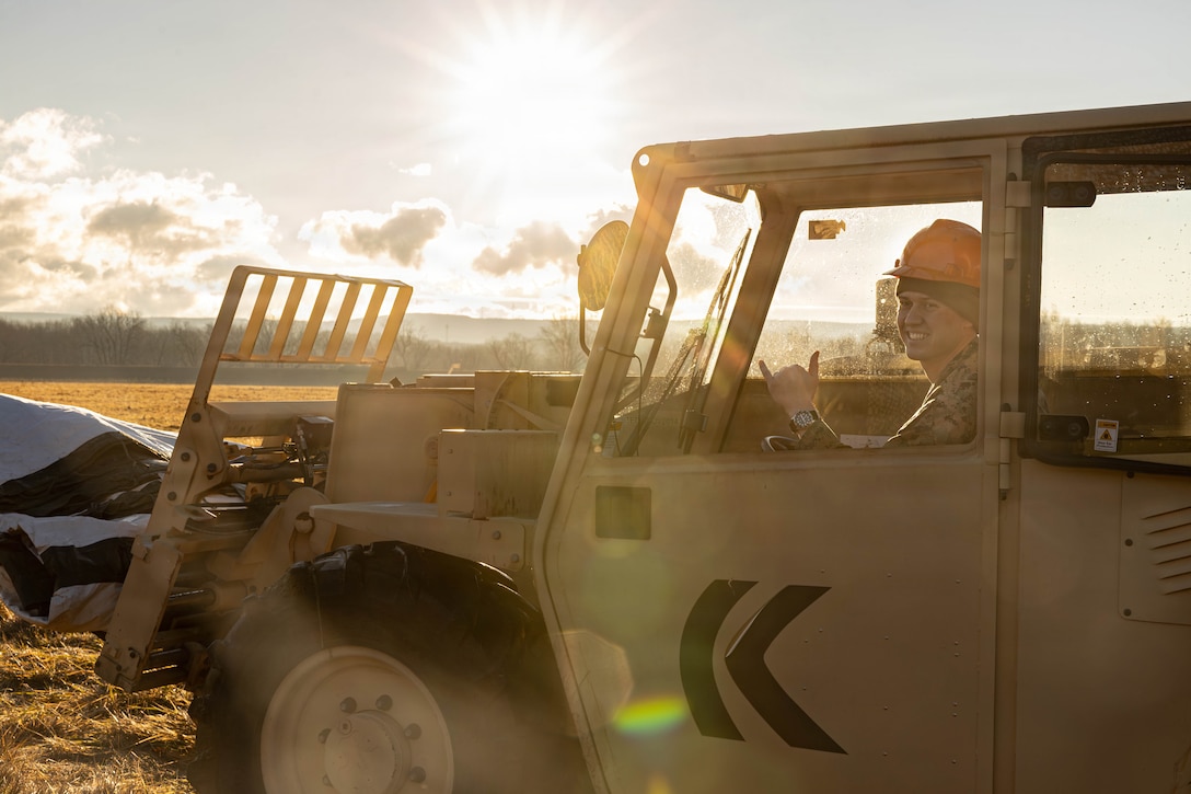 U.S. Marine Corps Sgt. Zachary Miller transports a water tank to the site for a food service competition at Marine Wing Support Squadron (MWSS) 472, Wyoming, Pennsylvania, Jan. 11, 2026. Miller is a motor transport operator with MWSS 472, Marine Aircraft Group 49, 4th Marine Aircraft Wing. Marines participated in an inspection for the Maj. Gen. William Pendleton Thompson Hill Awards to demonstrate their quality of food preparation, sanitation, and customer service. (U.S. Marine Corps photo by Lance Cpl. Priscilla Flores)