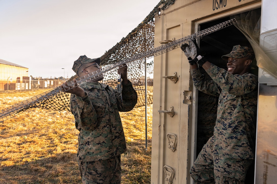 U.S. Marine Corps Lance Cpl. Bryce Frink (left) and Lance Cpl. Joseph Jeanty (right) haul equipment for a food service competition at Marine Wing Support Squadron (MWSS) 472, Wyoming, Pennsylvania, Jan. 11, 2026. Frink is a food service specialist and Jeanty is a motor vehicle operator with MWSS 472, Marine Aircraft Group 49, 4th Marine Aircraft Wing. Marines participated in an inspection for the Maj. Gen. William Pendleton Thompson Hill Awards to demonstrate their quality of food preparation, sanitation, and customer service. (U.S. Marine Corps photo by Lance Cpl. Priscilla Flores)