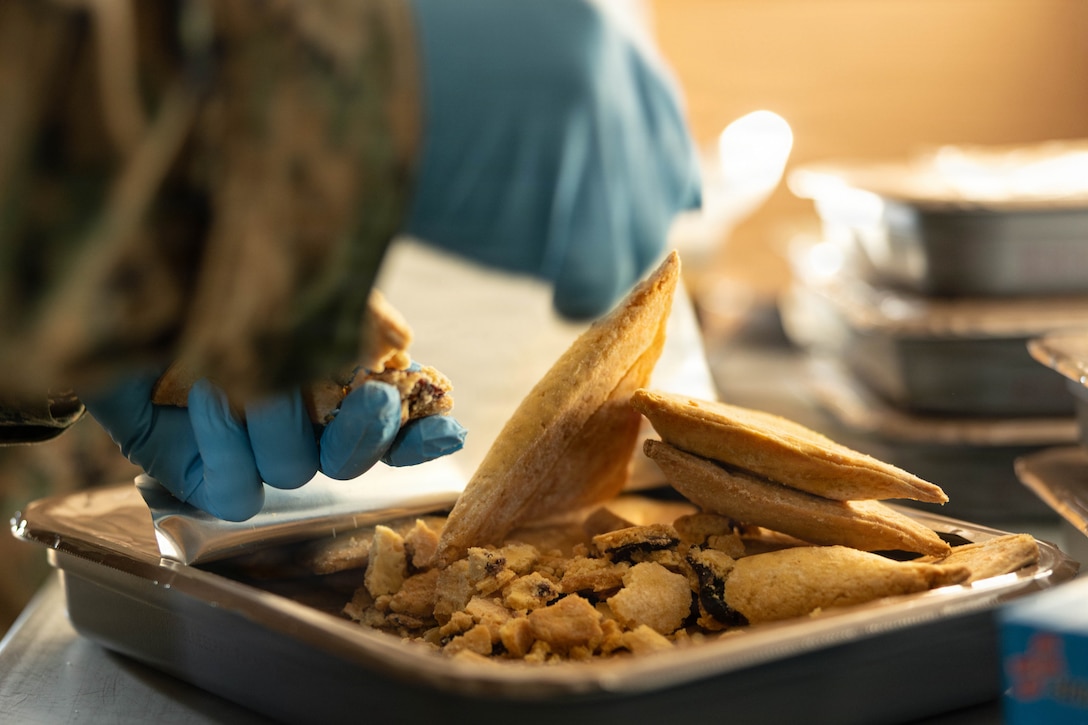 U.S. Marine Corps Pfc. Alexander Johnson crumbles a pastry for a food service competition at Marine Wing Support Squadron (MWSS) 472, Wyoming, Pennsylvania, Jan. 11, 2026. Johnson is a food service specialist with MWSS 472, Marine Aircraft Group 49, 4th Marine Aircraft Wing. Marines participated in an inspection for the Maj. Gen. William Pendleton Thompson Hill Awards to demonstrate their quality of food preparation, sanitation, and customer service. (U.S. Marine Corps photo by Lance Cpl. Priscilla Flores)