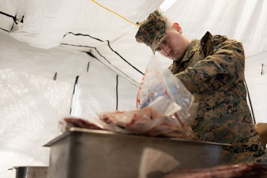 U.S. Marine Corps Lance Cpl. Rylan Cohen gathers pieces of steak for a food service competition at Marine Wing Support Squadron (MWSS) 472, Wyoming, Pennsylvania, Jan. 11, 2026. Cohen is a food service specialist with MWSS 472, Marine Aircraft Group 49, 4th Marine Aircraft Wing. Marines participated in an inspection for the Maj. Gen. William Pendleton Thompson Hill Awards to demonstrate their quality of food preparation, sanitation, and customer service. (U.S. Marine Corps photo by Lance Cpl. Priscilla Flores)