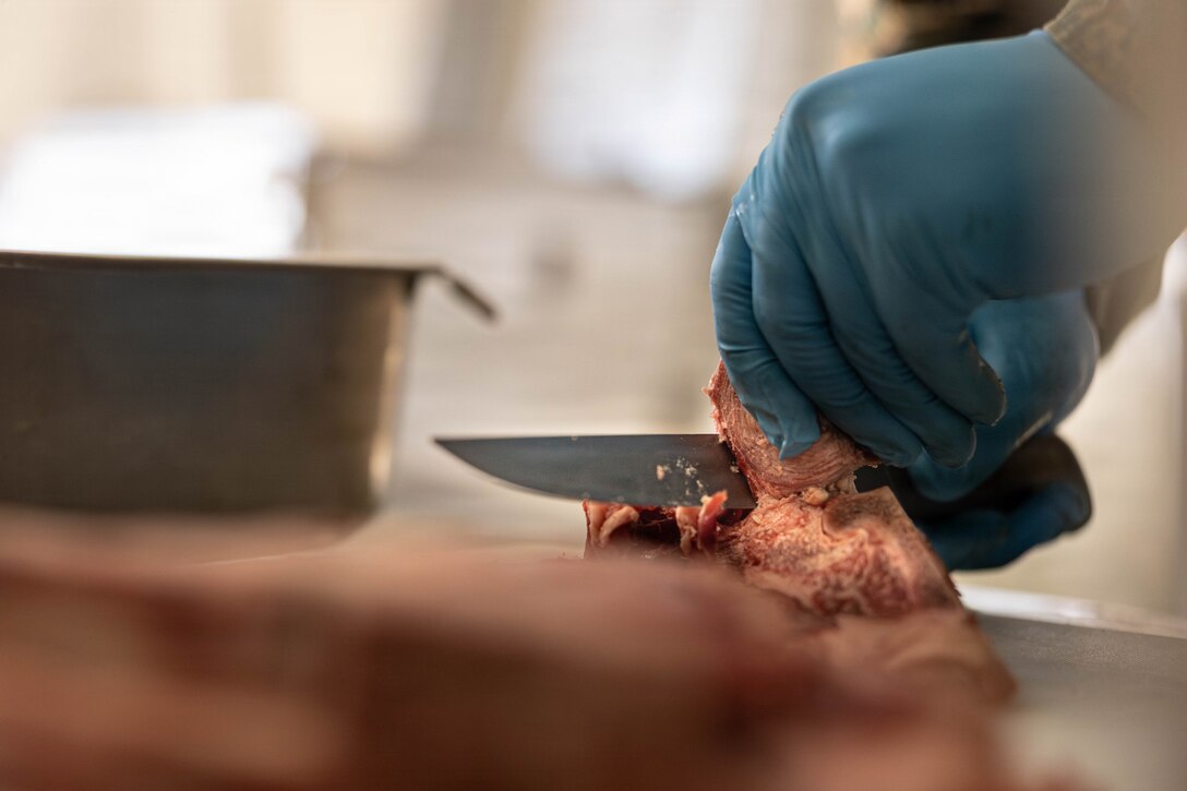 U.S. Marine Corps Lance Cpl. Rylan Cohen slices steak for a food service competition at Marine Wing Support Squadron (MWSS) 472, Wyoming, Pennsylvania, Jan. 11, 2026. Cohen is a food service specialist with MWSS 472, Marine Aircraft Group 49, 4th Marine Aircraft Wing. Marines participated in an inspection for the Maj. Gen. William Pendleton Thompson Hill Awards to demonstrate their quality of food preparation, sanitation, and customer service. (U.S. Marine Corps photo by Lance Cpl. Priscilla Flores)