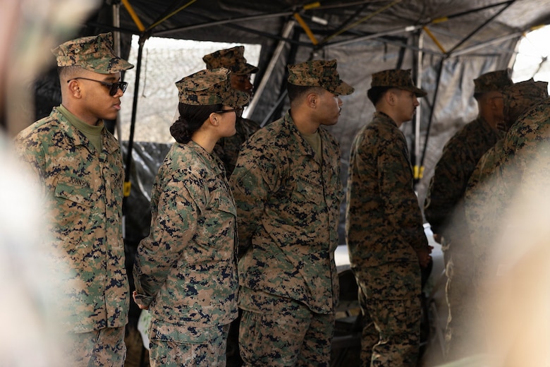 U.S. Marines wait for their prepared meals to be reviewed during a food service competition at Marine Wing Support Squadron (MWSS) 472, Wyoming, Pennsylvania, Jan. 11, 2026. Marines participated in an inspection for the Maj. Gen. William Pendleton Thompson Hill Awards to demonstrate their quality of food preparation, sanitation, and customer service. (U.S. Marine Corps photo by Lance Cpl. Priscilla Flores)