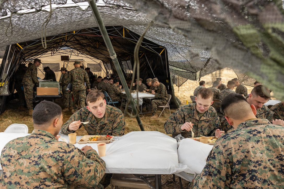 U.S. Marines eat the meals prepared during a food service competition at Marine Wing Support Squadron (MWSS) 472, Wyoming, Pennsylvania, Jan. 11, 2026. Marines participated in an inspection for the Maj. Gen. William Pendleton Thompson Hill Awards to demonstrate their quality of food preparation, sanitation, and customer service. (U.S. Marine Corps photo by Lance Cpl. Priscilla Flores)