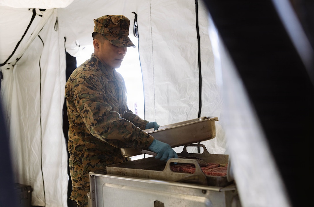 U.S. Marine Corps Lance Cpl. Anderson Chicaizaguachamin grills steak during a food service competition at Marine Wing Support Squadron (MWSS) 472, Wyoming, Pennsylvania, Jan. 11, 2026. Chicaizaguachamin is a food service specialist with MWSS 472, Marine Aircraft Group 49, 4th Marine Aircraft Wing. Marines participated in an inspection for the Maj. Gen. William Pendleton Thompson Hill Awards to demonstrate their quality of food preparation, sanitation, and customer service. (U.S. Marine Corps photo by Lance Cpl. Priscilla Flores)