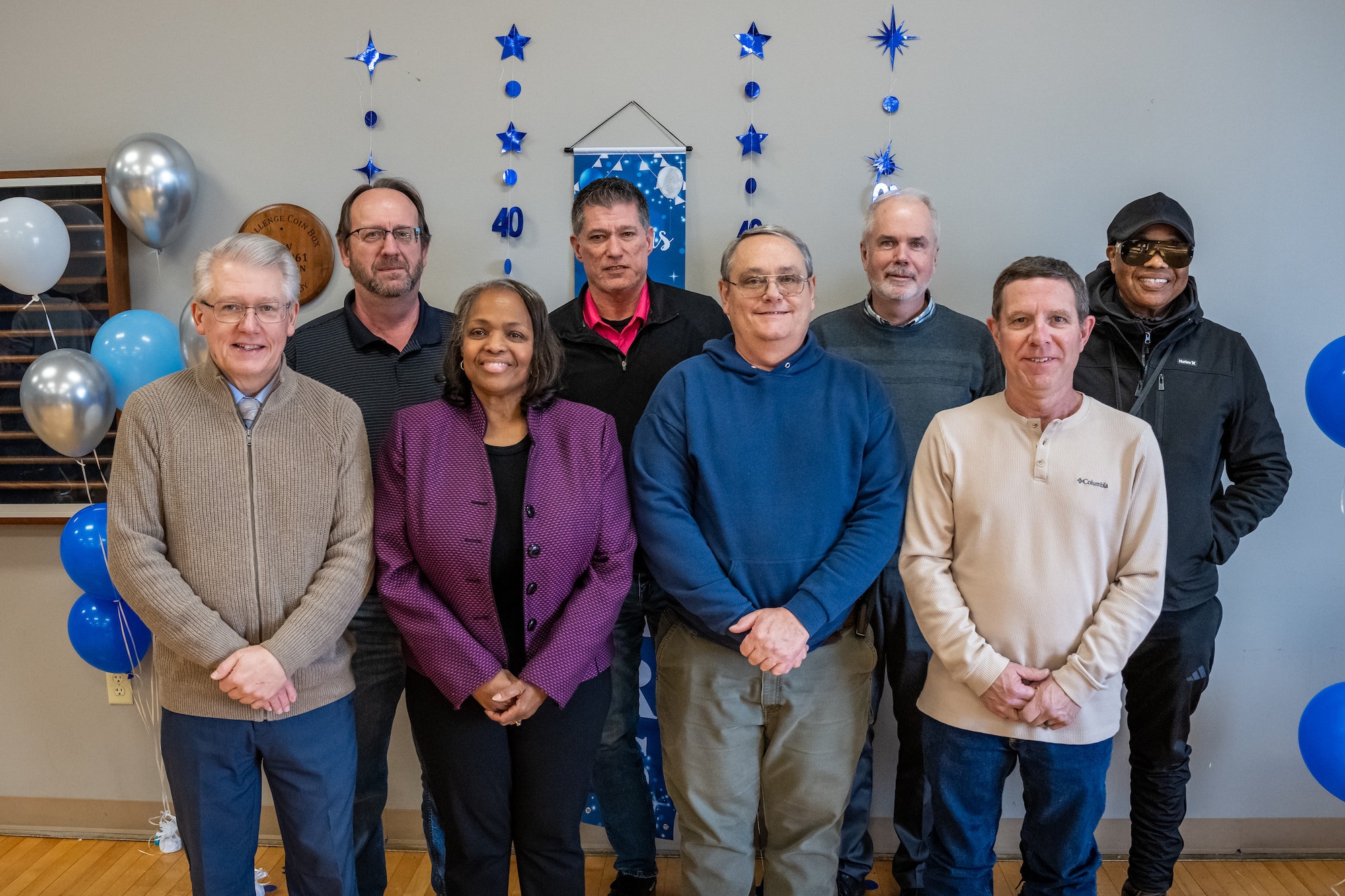 A group photo of eight civilians