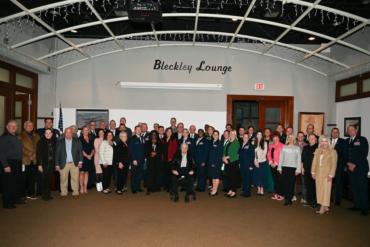 McConnell leadership, golden eagles and past and present honorary commanders, pose for a photo.