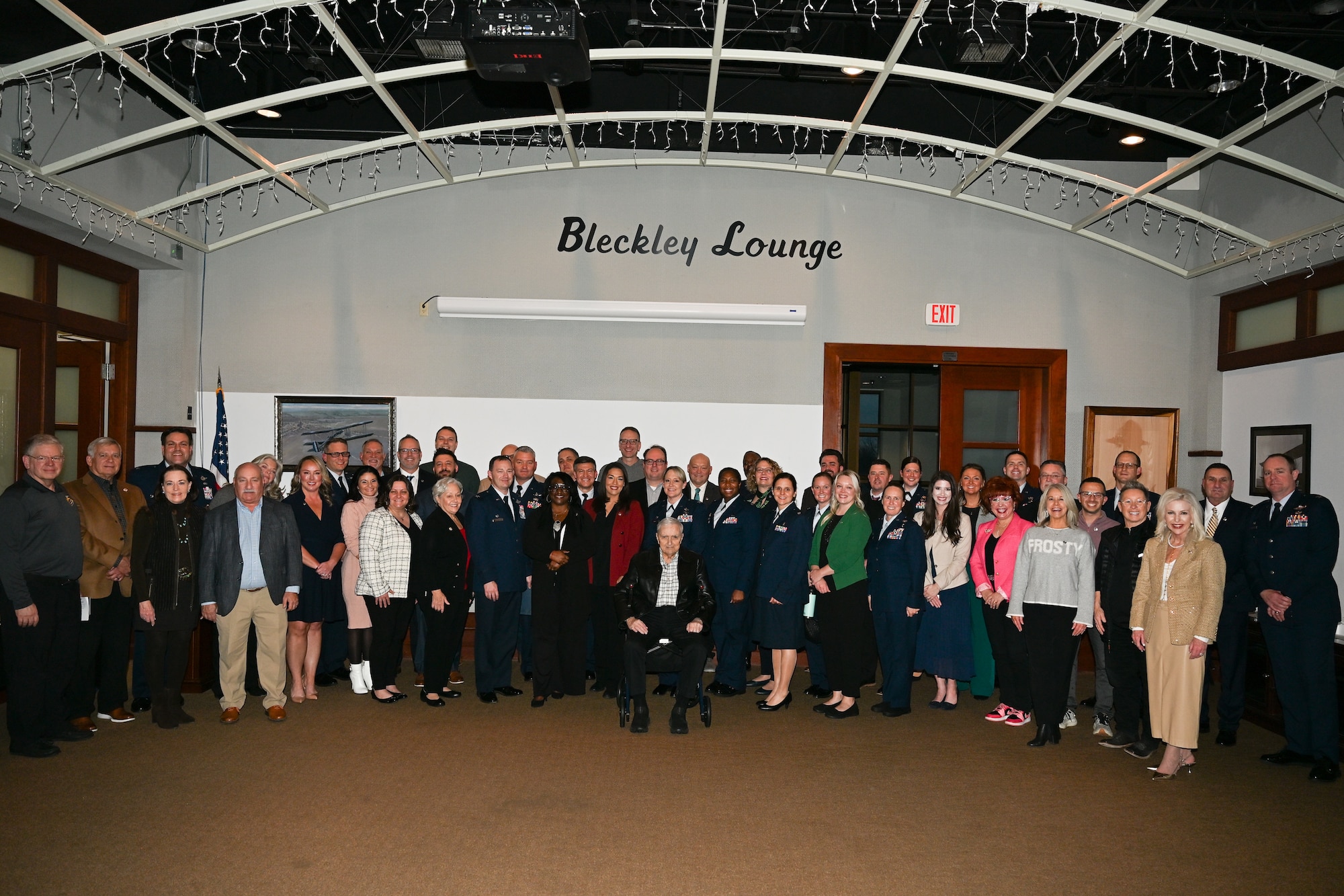 McConnell leadership, golden eagles and past and present honorary commanders, pose for a photo.