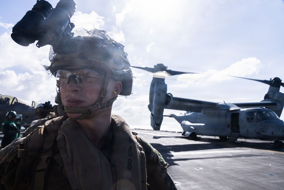 A U.S. Marine with Weapons Company, Battalion Landing Team 3rd Battalion, 1st Marine Regiment, 31st Marine Expeditionary Unit, coffloads an MV-22B Osprey assigned to Marine Medium Tiltrotor Squadron (VMM) 265 (Rein.), 31st Marine Expeditionary Unit, aboard the forward-deployed amphibious assault carrier USS Tripoli (LHA 7), flagship of the Tripoli Expeditionary Strike Group, Dec. 14, 2025.