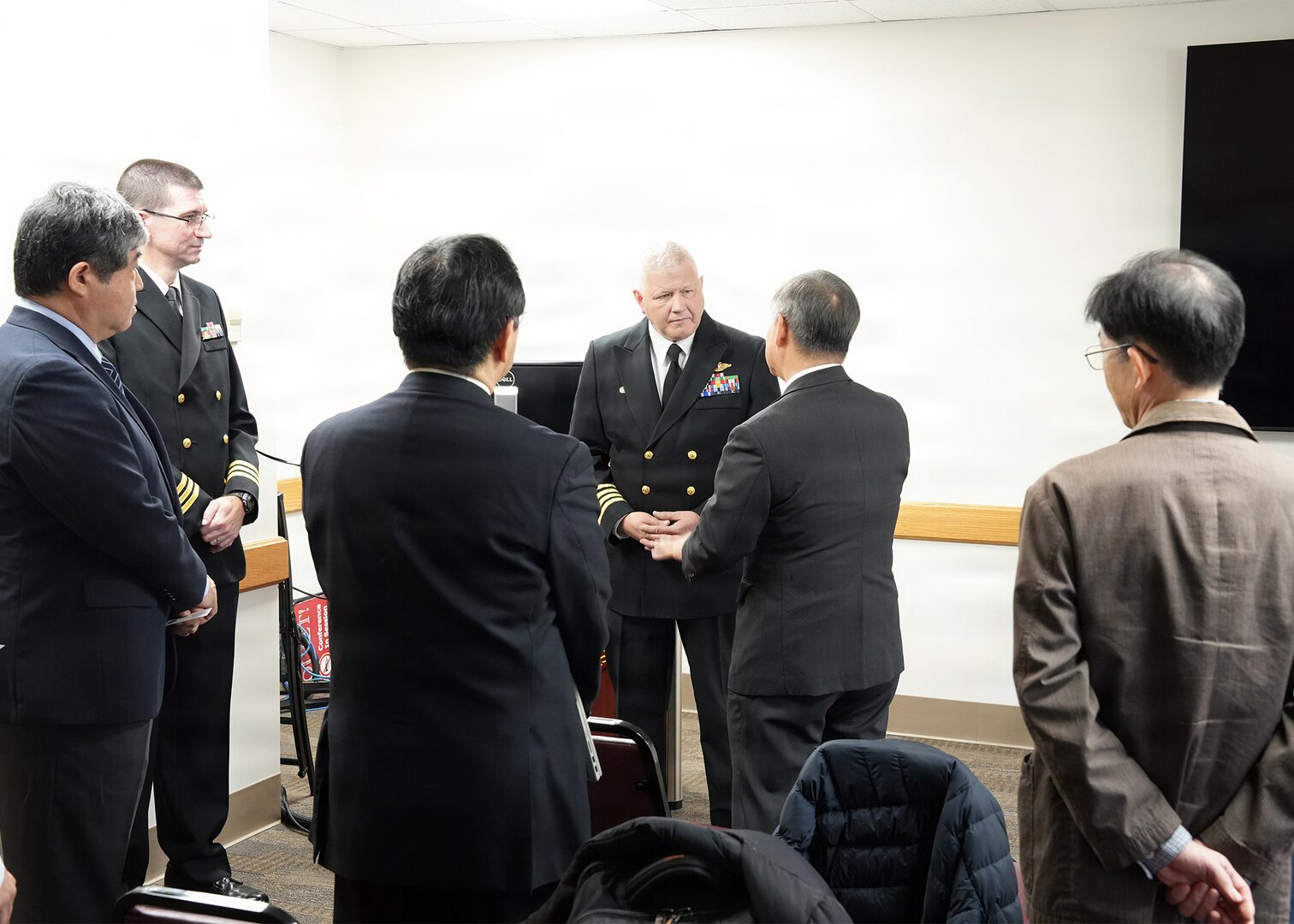 JOINT BASE SAN ANTONIO-FORT SAM HOUSTON – (Jan. 13, 2026) – Commanding Officer Capt. Michael Tiller, Medical Corps, Naval Medical Research Unit (NAMRU) San Antonio, joined by Executive Officer Cmdr. Nicholas Hamlin, Dental Corps, greets representatives of Japan’s National Defense Medical College (NDMC) at the Battlefield Health and Trauma Research Institute.  The visit, led by Dr. Manabu Kinoshita, NDMC’s chairman professor, Department of Immunology and Microbiology, continues a sustained partnership between NAMRU San Antonio and NDMC to enhance each other’s capabilities to counteract emerging threats, benefiting military health as well as global health security. Navy Medicine Research & Development (NMR&D) contributes directly to positive working relationships with partner nation militaries, keeping the scope of Department of War capabilities wide, and at the ready, to address emerging threats aboard. NAMRU San Antonio, part of NMR&D, conducts gap-driven combat casualty care, craniofacial, and directed energy research in support of Navy, Marine Corps and joint U.S. warfighter health readiness and lethality while engaged in routine and expeditionary operations. (U.S. Navy photo by Burrell Parmer, NAMRU San Antonio Public Affairs/Released)