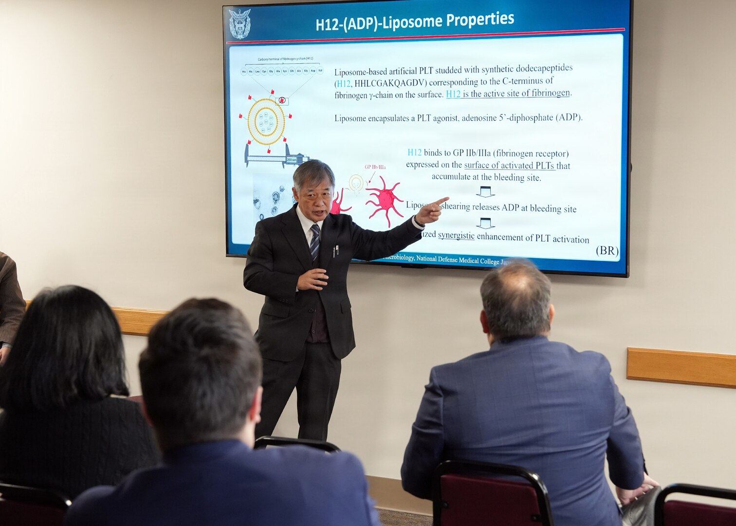 JOINT BASE SAN ANTONIO-FORT SAM HOUSTON – (Jan. 13, 2026) – Dr. Manabu Kinoshita, Japan’s National Defense Medical College’s (NDMC) chairman professor, Department of Immunology and Microbiology, briefs leadership and research scientists assigned to Naval Medical Research Unit (NAMRU) San Antonio of research on the development of whole blood analog in Japan at the Battlefield Health and Trauma Research Institute.  The briefing continues a sustained partnership between NAMRU San Antonio and NDMC to enhance each other’s capabilities to counteract emerging threats, benefiting military health as well as global health security. Navy Medicine Research & Development (NMR&D) contributes directly to positive working relationships with partner nation militaries, keeping the scope of Department of War capabilities wide, and at the ready, to address emerging threats aboard. NAMRU San Antonio, part of NMR&D, conducts gap-driven combat casualty care, craniofacial, and directed energy research in support of Navy, Marine Corps and joint U.S. warfighter health readiness and lethality while engaged in routine and expeditionary operations. (U.S. Navy photo by Burrell Parmer, NAMRU San Antonio Public Affairs/Released)