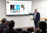 JOINT BASE SAN ANTONIO-FORT SAM HOUSTON – (Jan. 13, 2026) – Dr. Darrin Frye, Naval Medical Research Unit (NAMRU) San Antonio’s chief science director, briefs research on XSTAT and other capabilities to representatives of Japan’s National Defense Medical College (NDMC) at the Battlefield Health and Trauma Research Institute.  The visit, led by Dr. Manabu Kinoshita, NDMC’s chairman professor, Department of Immunology and Microbiology, continues a sustained partnership between NAMRU San Antonio and NDMC to enhance each other’s capabilities to counteract emerging threats, benefiting military health as well as global health security. Navy Medicine Research & Development (NMR&D) contributes directly to positive working relationships with partner nation militaries, keeping the scope of Department of War capabilities wide, and at the ready, to address emerging threats aboard. NAMRU San Antonio, part of NMR&D, conducts gap-driven combat casualty care, craniofacial, and directed energy research in support of Navy, Marine Corps and joint U.S. warfighter health readiness and lethality while engaged in routine and expeditionary operations. (U.S. Navy photo by Burrell Parmer, NAMRU San Antonio Public Affairs/Released)