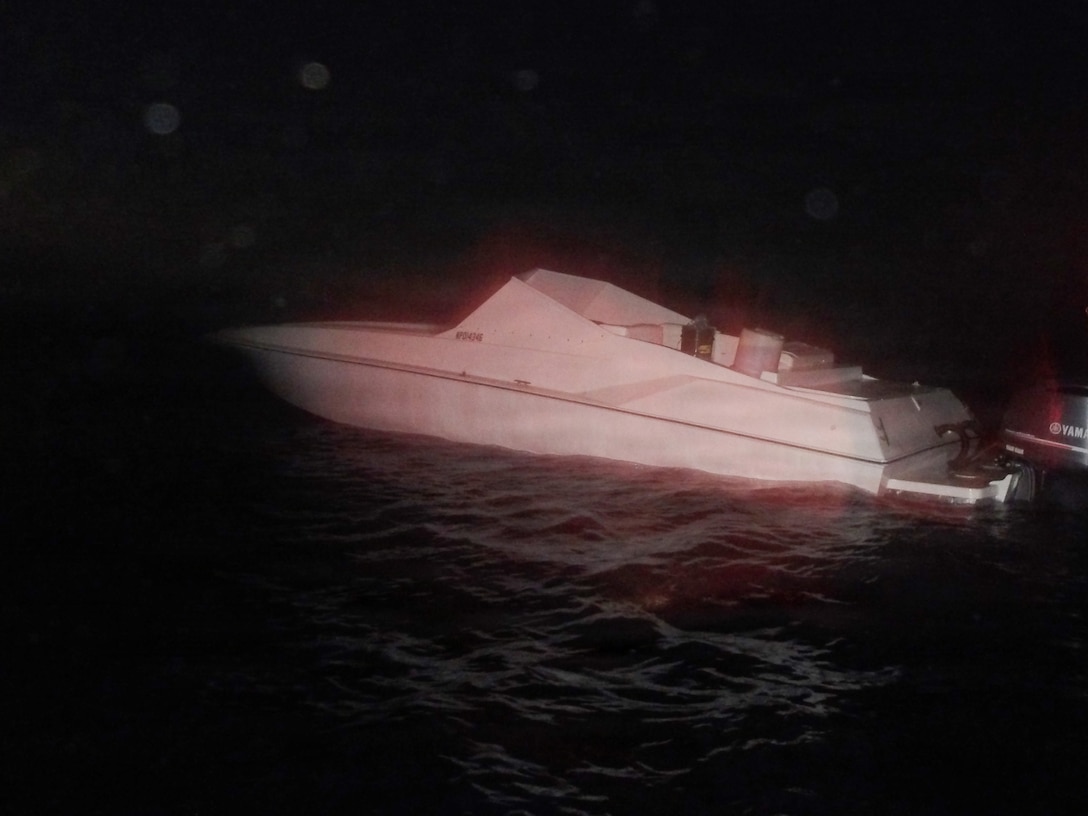 A go-fast style vessel trafficking illegal narcotics in the Windward Passage sits idle late in the evening, Dec. 6, 2025, after it was interdicted by a Coast Guard Cutter Alert (WMEC 630) small boat crew. Alert's crew seized 2,250 pounds of cocaine valued at $18.4 million, seven pounds of marijuana valued at $7,000 and an illegal firearm, later transferring the narcotics, firearm and four suspected drug smugglers aboard to the Bahamas government for prosecution. (U.S. Coast Guard photo)