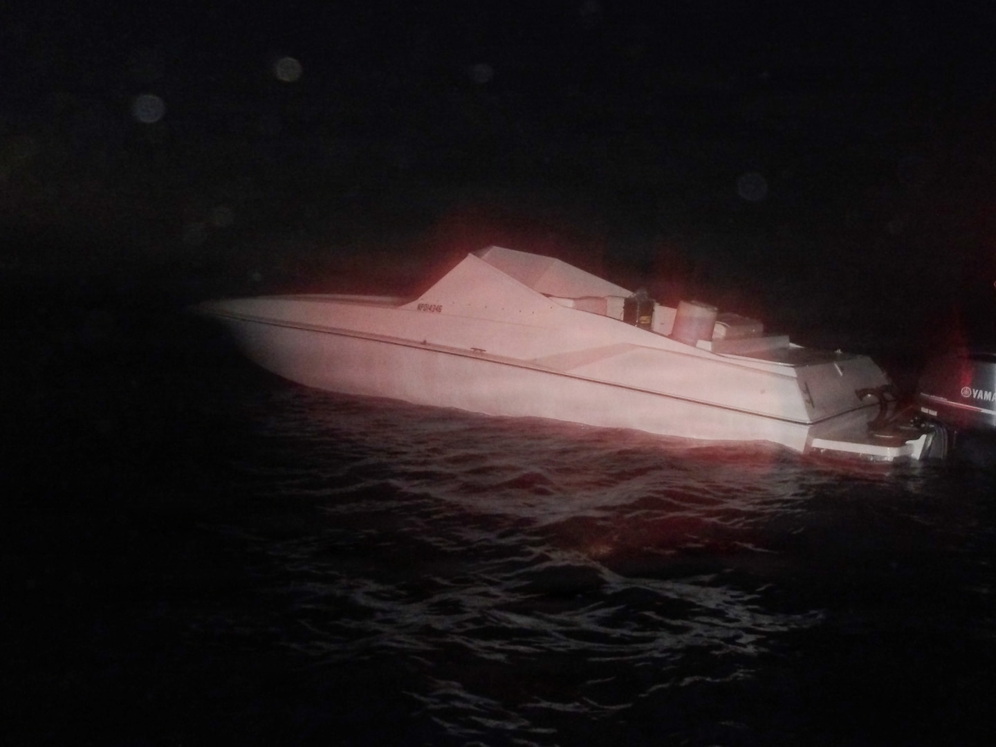 A go-fast style vessel trafficking illegal narcotics in the Windward Passage sits idle late in the evening, Dec. 6, 2025, after it was interdicted by a Coast Guard Cutter Alert (WMEC 630) small boat crew. Alert's crew seized 2,250 pounds of cocaine valued at $18.4 million, seven pounds of marijuana valued at $7,000 and an illegal firearm, later transferring the narcotics, firearm and four suspected drug smugglers aboard to the Bahamas government for prosecution. (U.S. Coast Guard photo)