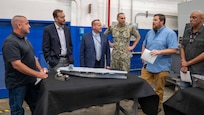 r. Adam Smith, an employee with the Fabrication and Technical Support Division (second from right), explains the assembly of the physical models to visitors at Naval Surface Warfare Center, Carderock Division in West Bethesda on Aug. 28, 2025. Pictured from left are: Mr. Josh Crum; Mr. Chris Miller, Executive Director of Naval Sea Systems Command; Mr. Tom Perotti, Executive Director, Naval Sea Systems Command, Engineering and Logistics (SEA 05), and (Acting) Executive Director Naval Surface and Undersea Warfare Centers; Capt. Chris Matassa, Carderock's Commanding Officer; and Mr. Alexis Colon.