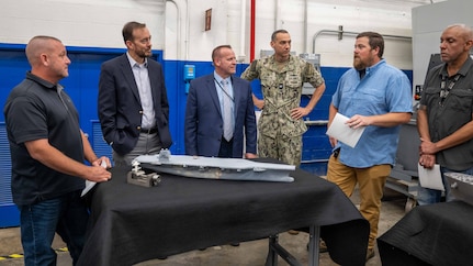 r. Adam Smith, an employee with the Fabrication and Technical Support Division (second from right), explains the assembly of the physical models to visitors at Naval Surface Warfare Center, Carderock Division in West Bethesda on Aug. 28, 2025. Pictured from left are: Mr. Josh Crum; Mr. Chris Miller, Executive Director of Naval Sea Systems Command; Mr. Tom Perotti, Executive Director, Naval Sea Systems Command, Engineering and Logistics (SEA 05), and (Acting) Executive Director Naval Surface and Undersea Warfare Centers; Capt. Chris Matassa, Carderock's Commanding Officer; and Mr. Alexis Colon.
