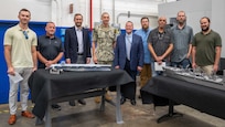 Mr. Christopher Miller and Mr. Thomas Perotti visited Carderock on Aug. 28, 2025, to recognize of team of Carderock employees who fabricated four 1/250th scale surface ship models in eight calendar days at the request of NAVSEA. From left to right: Matthew Gutmann (Code 822 Engineer), Josh Crum (Code 621 Branch Head), Mr. Miller (Executive Director NAVSEA), Captain Matassa (Commanding Officer NSWC Carderock), Mr. Perotti (Executive Director Warfare Centers), Adam Smith, (Code 621 Additive and Subtractive Technician), Alexis Colon (Code 621 Additive and Subtractive Technician), Tim Lewis (Code 623 Planner and Estimator) and John Grant Dixon (Code 822 Engineer).