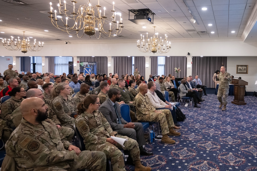 A crowd looks at a speaker during an event.