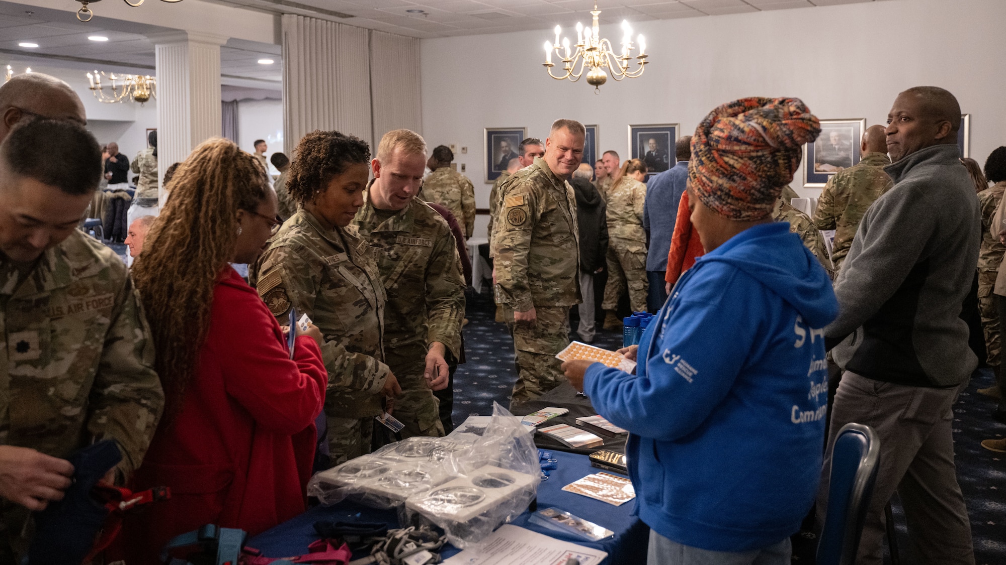 People gather around a set of tables.