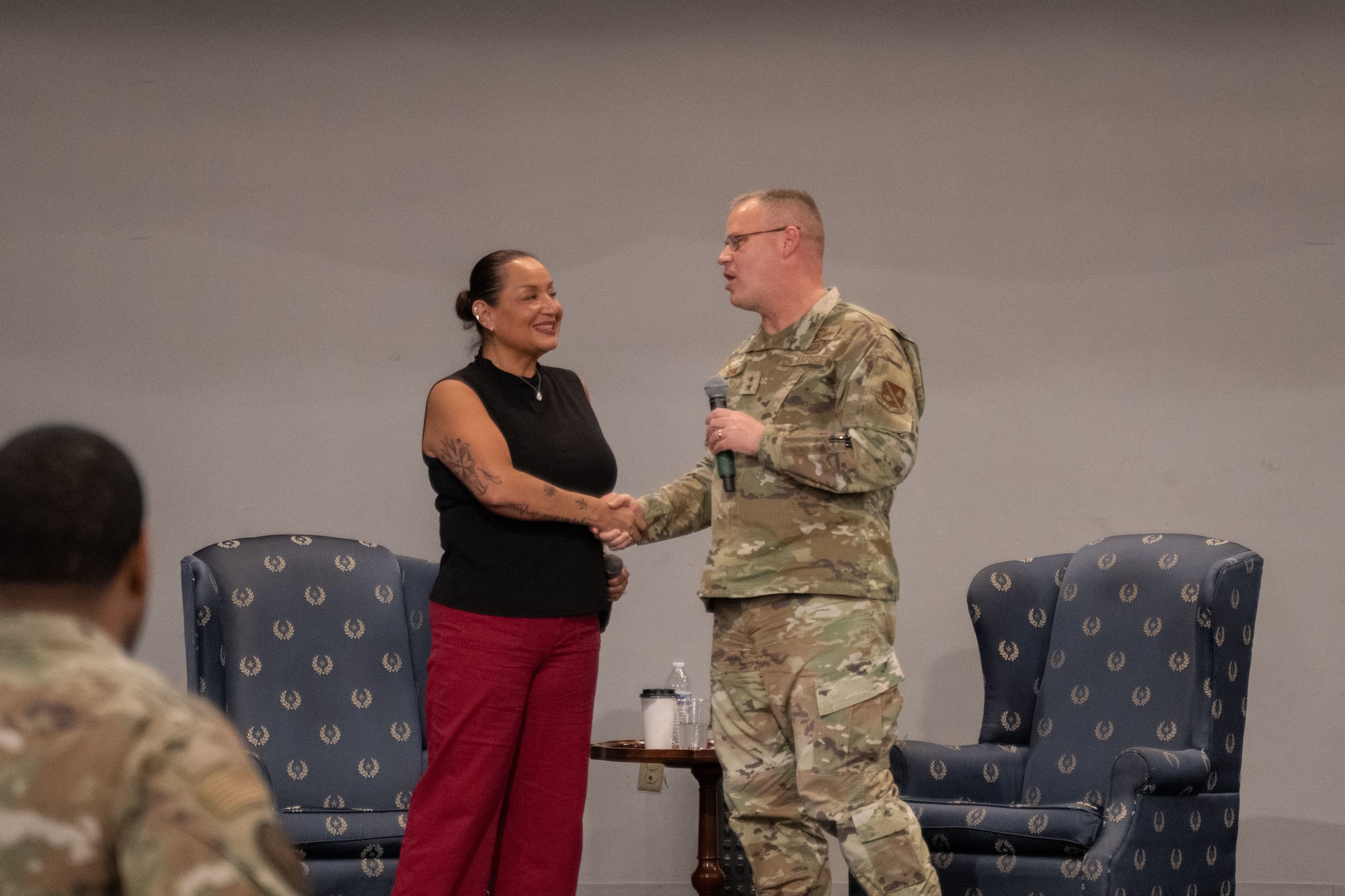 A man and woman shake hands.