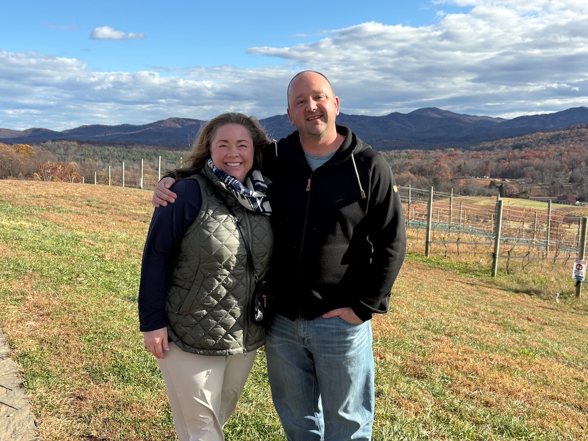 two people standing in field