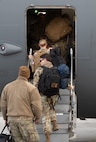 U.S. Air Force Airmen board a C17 Globemaster III.